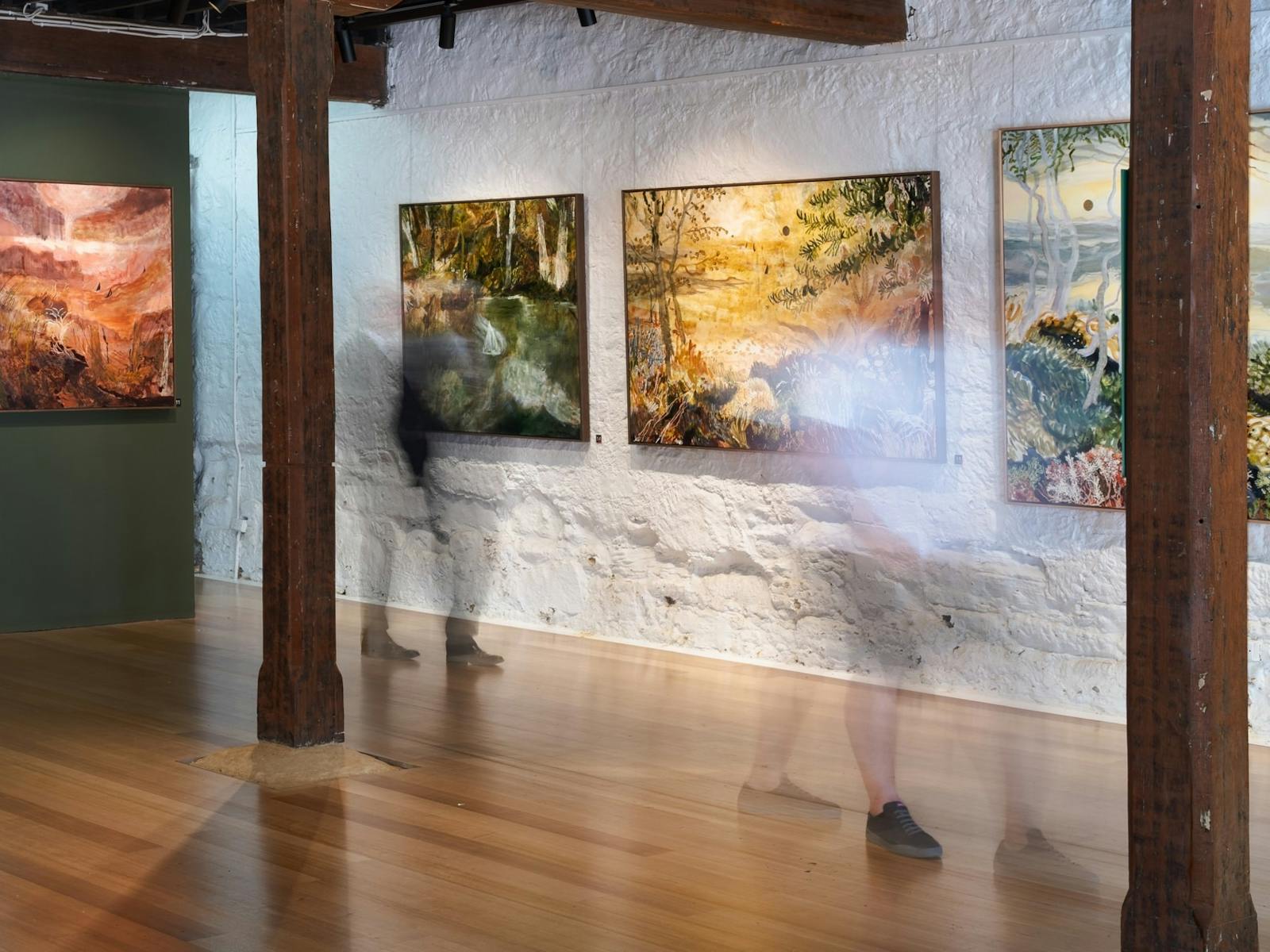 Image of Anna Fitzpatrick's 2024 exhibition titled Sydney to Hobart, with people viewing paintings.