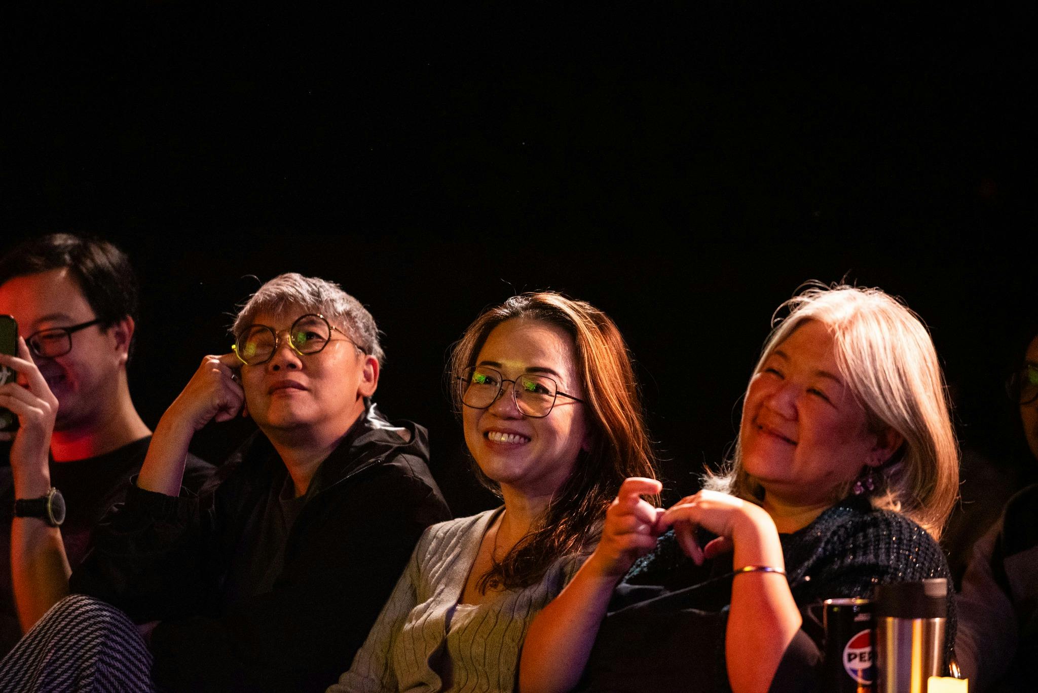 Audience members laughing during a live comedy performance at The Comedy Store Sydney.