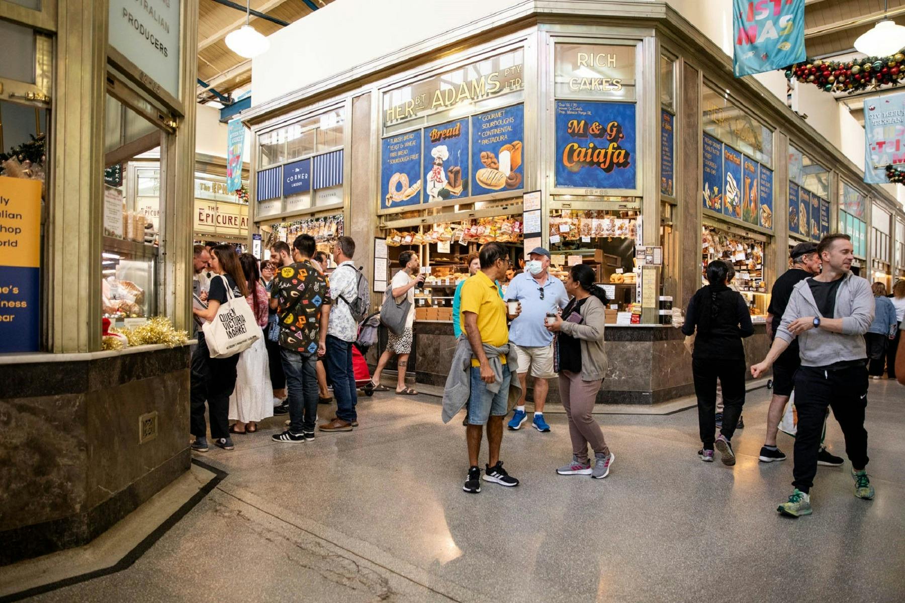 An aisle of Queen Victoria Market with people around