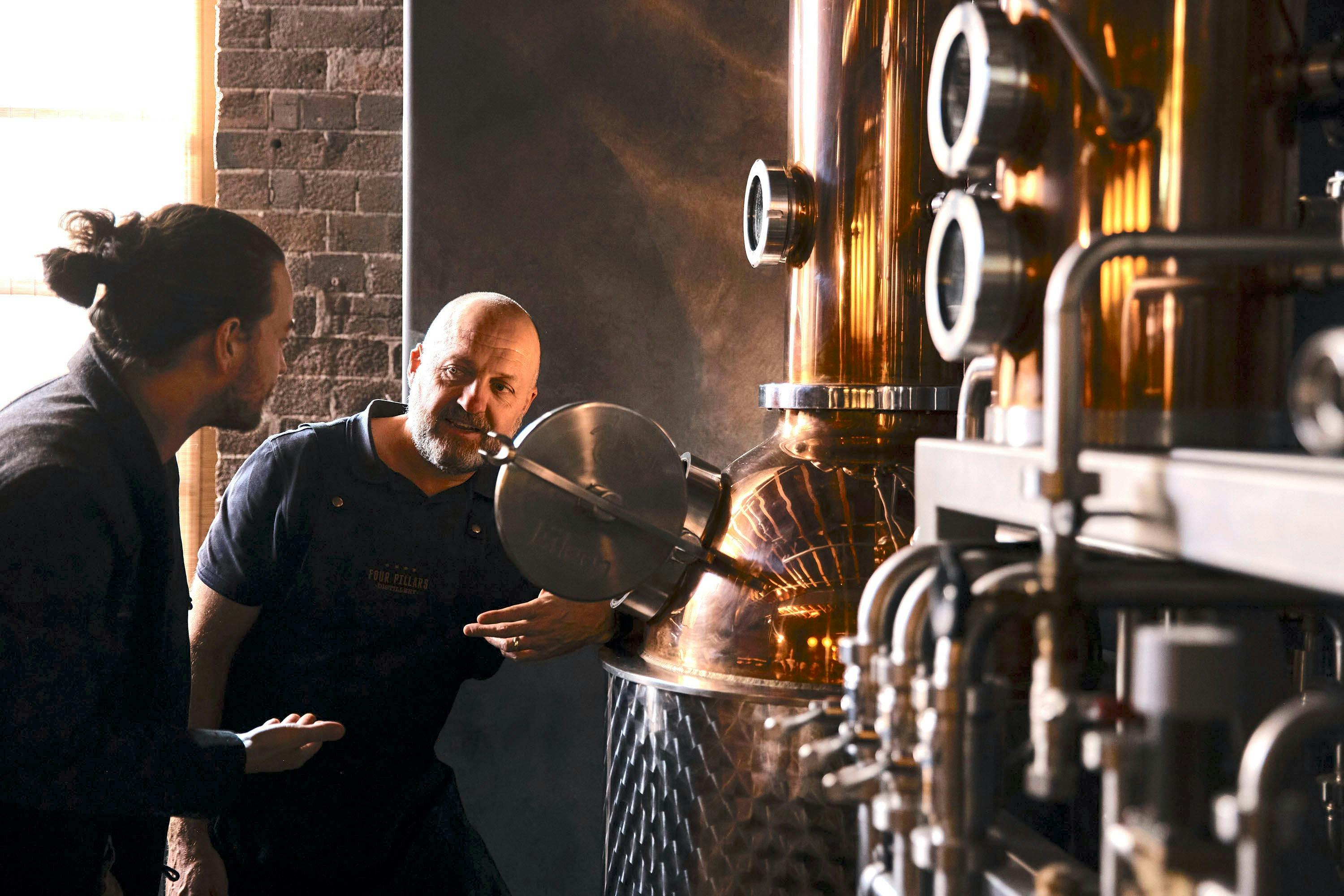 A distiller showing someone a still