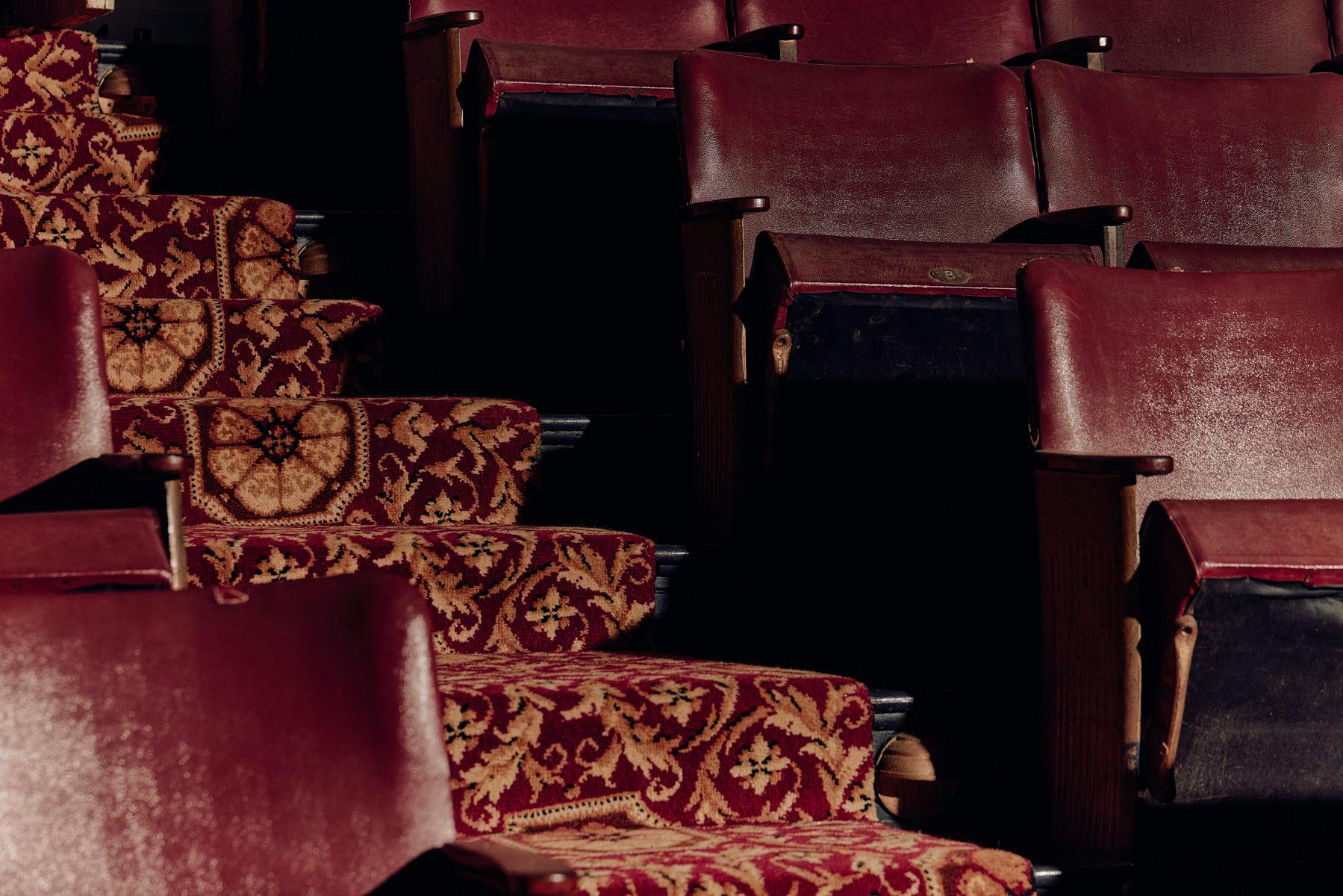 Art deco-era red leather seats with gold and red carpet