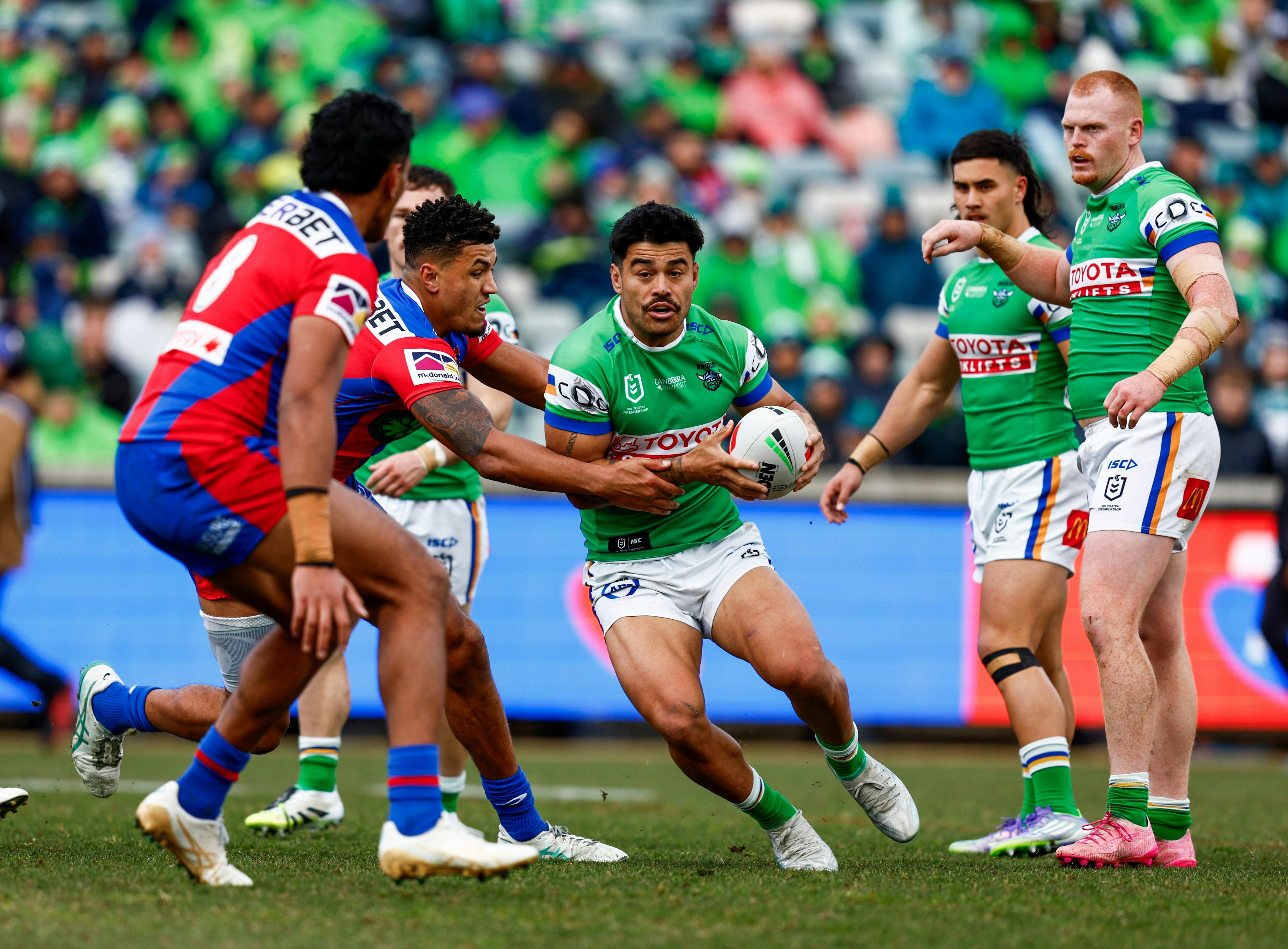 Canberra Raiders player Matthew Timoko running the ball,