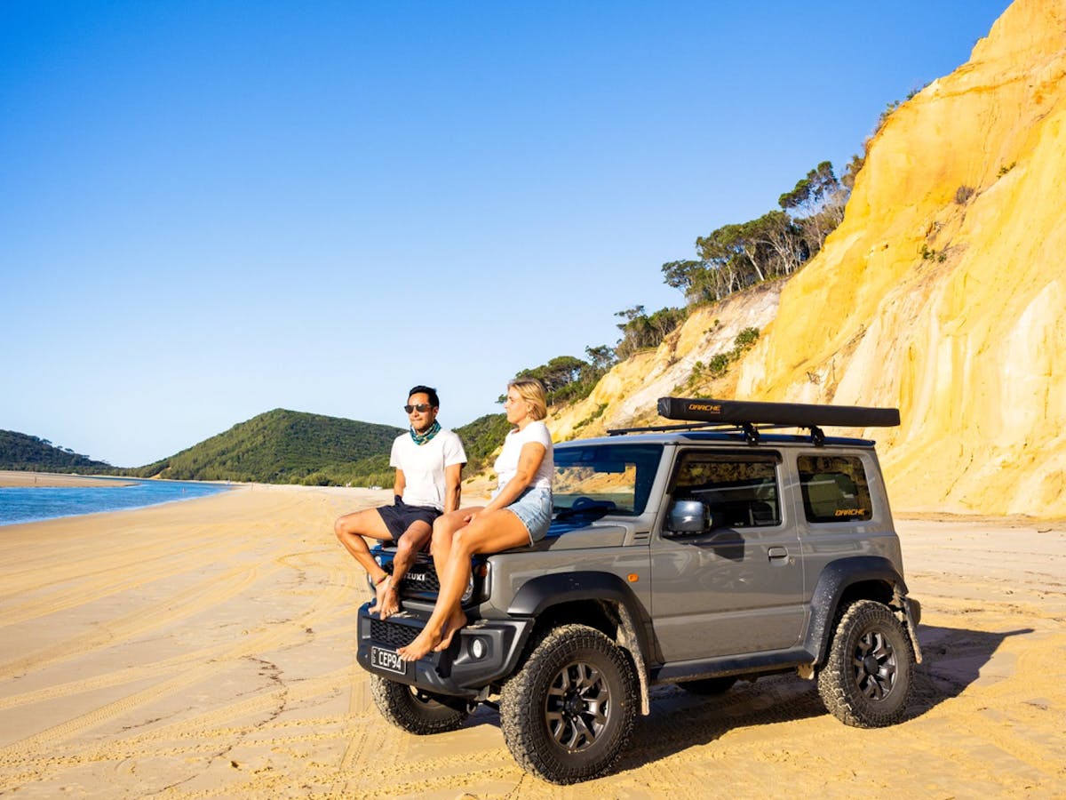 People with their car on the beach People with their car on the beach