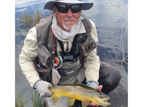 Nick May holding a brown trout