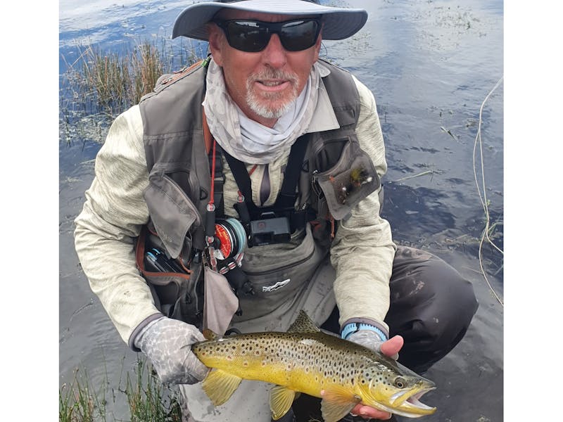 Nick May holding a brown trout