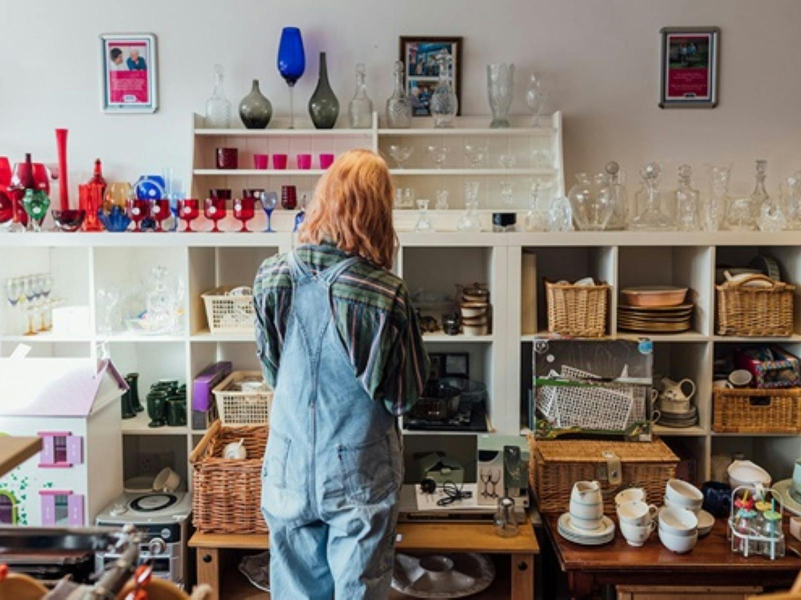 Image of a lady looking at second-hand homewares for sale