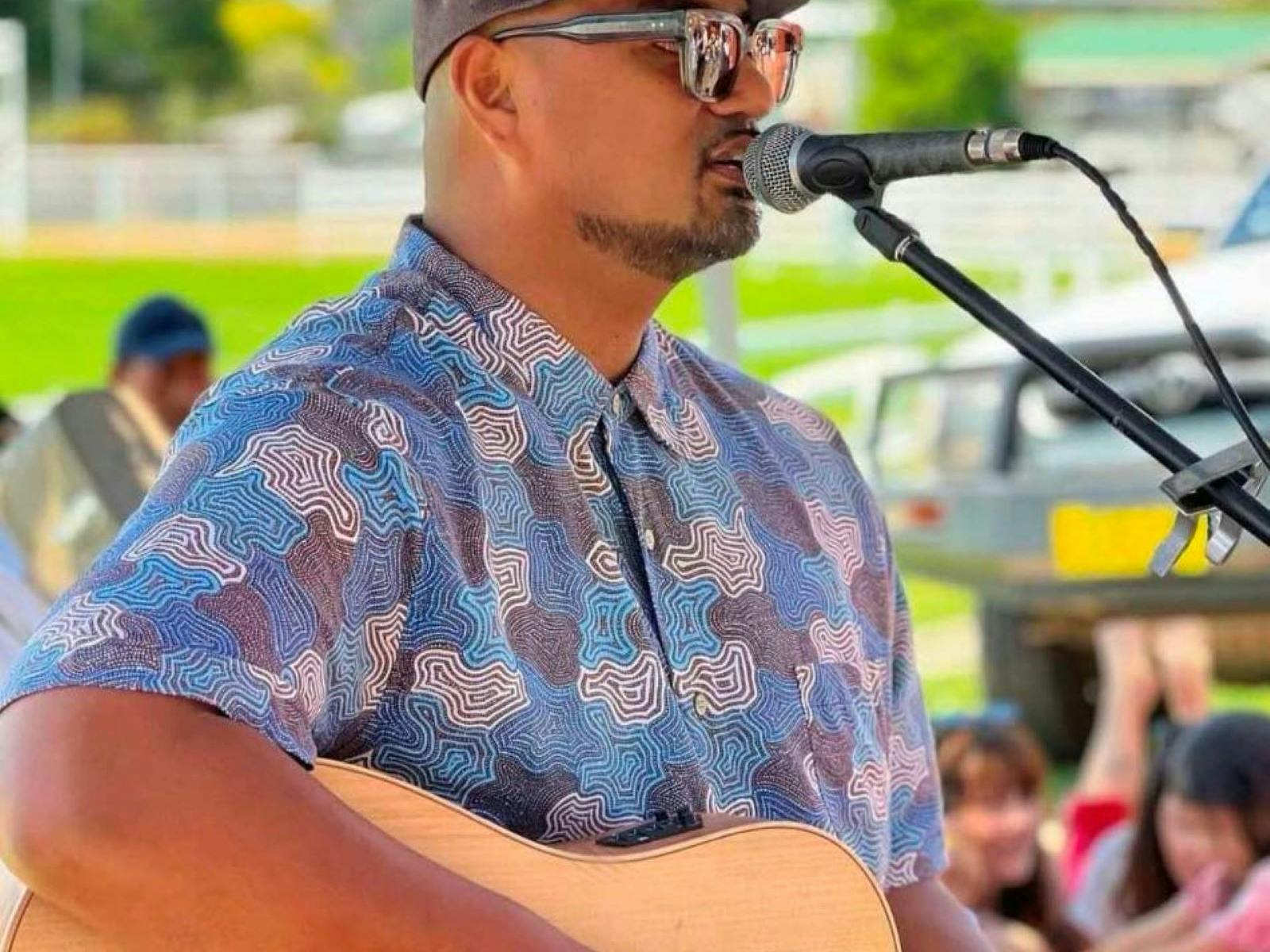Man singing and playing guitar