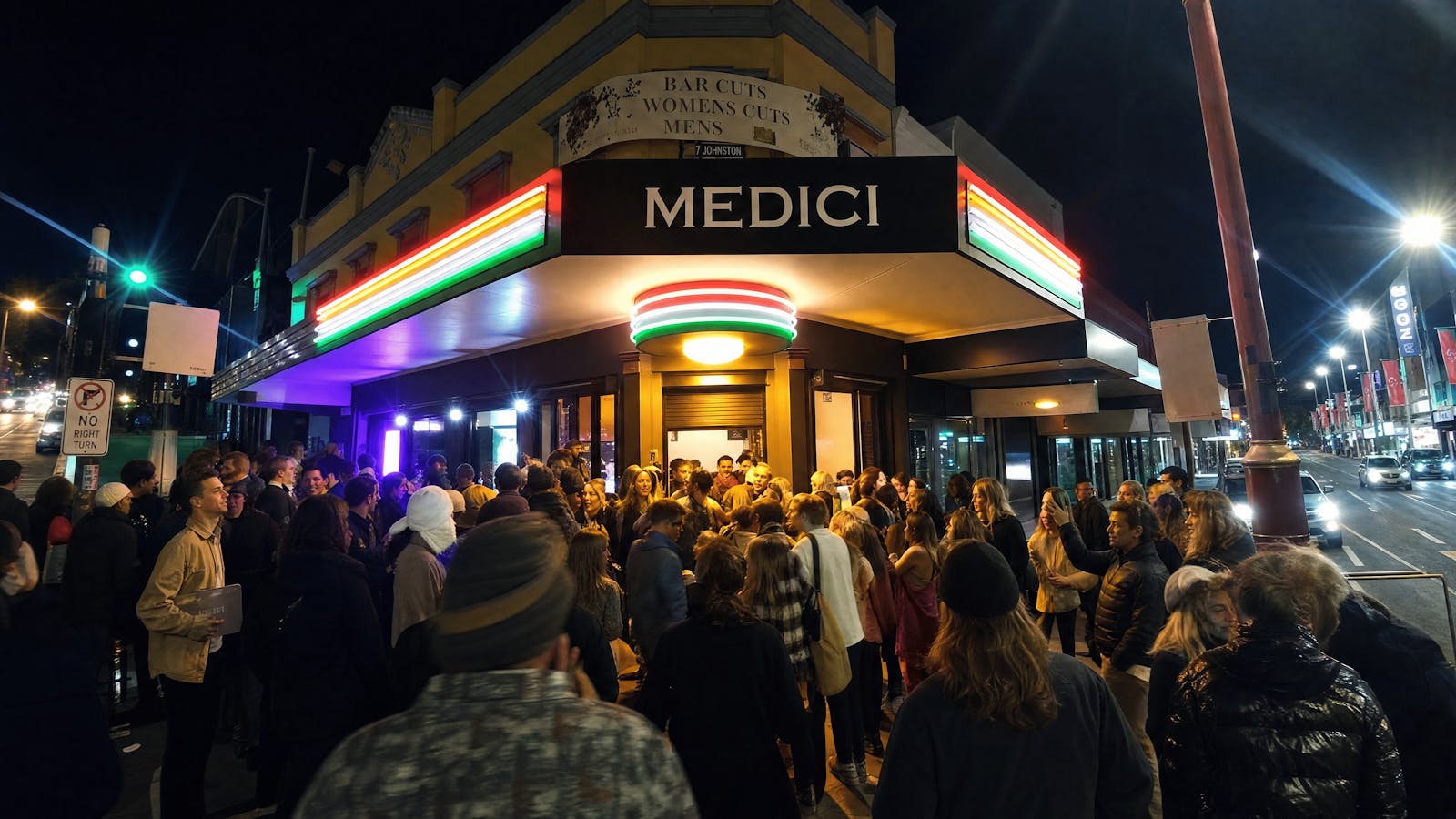An evening crowd outside Medici Pizzeria