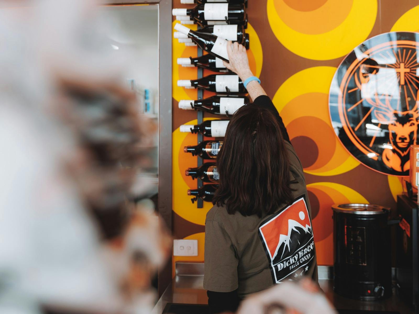 와인 랙에서 와인병을 꺼내는 직원