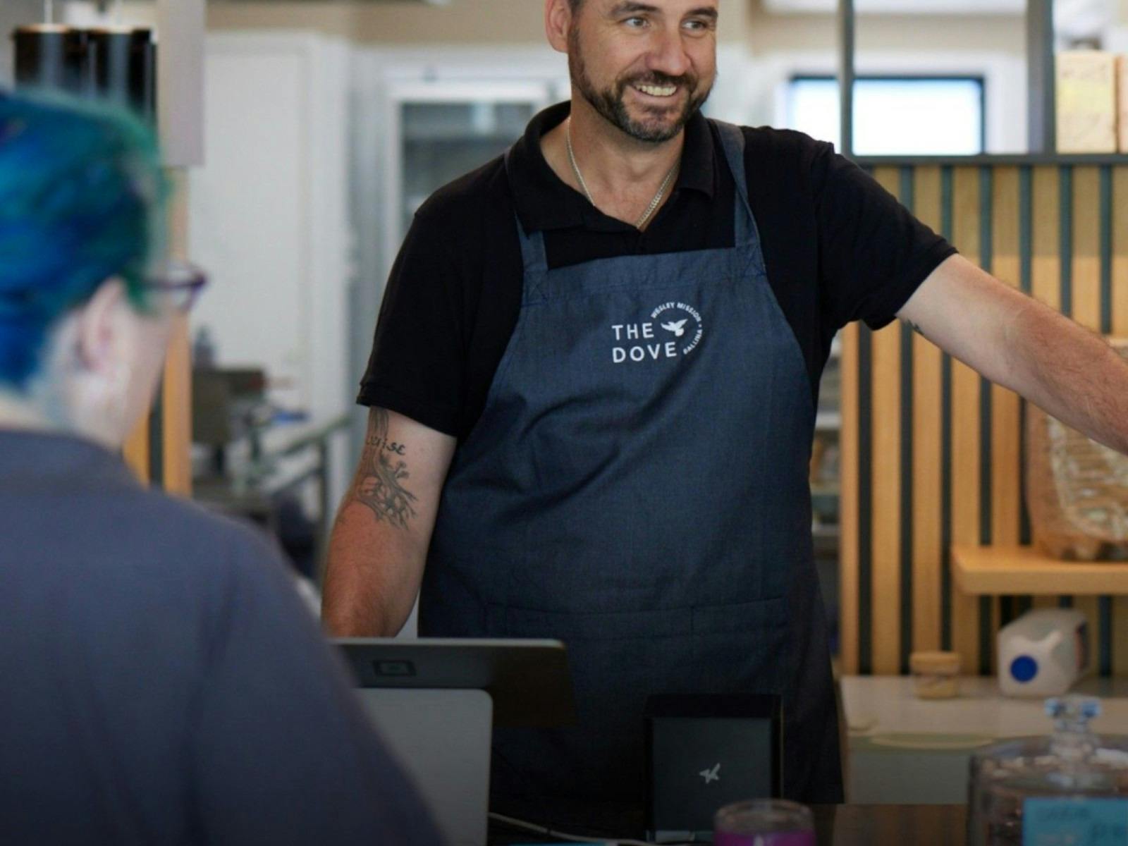 a barista smiling