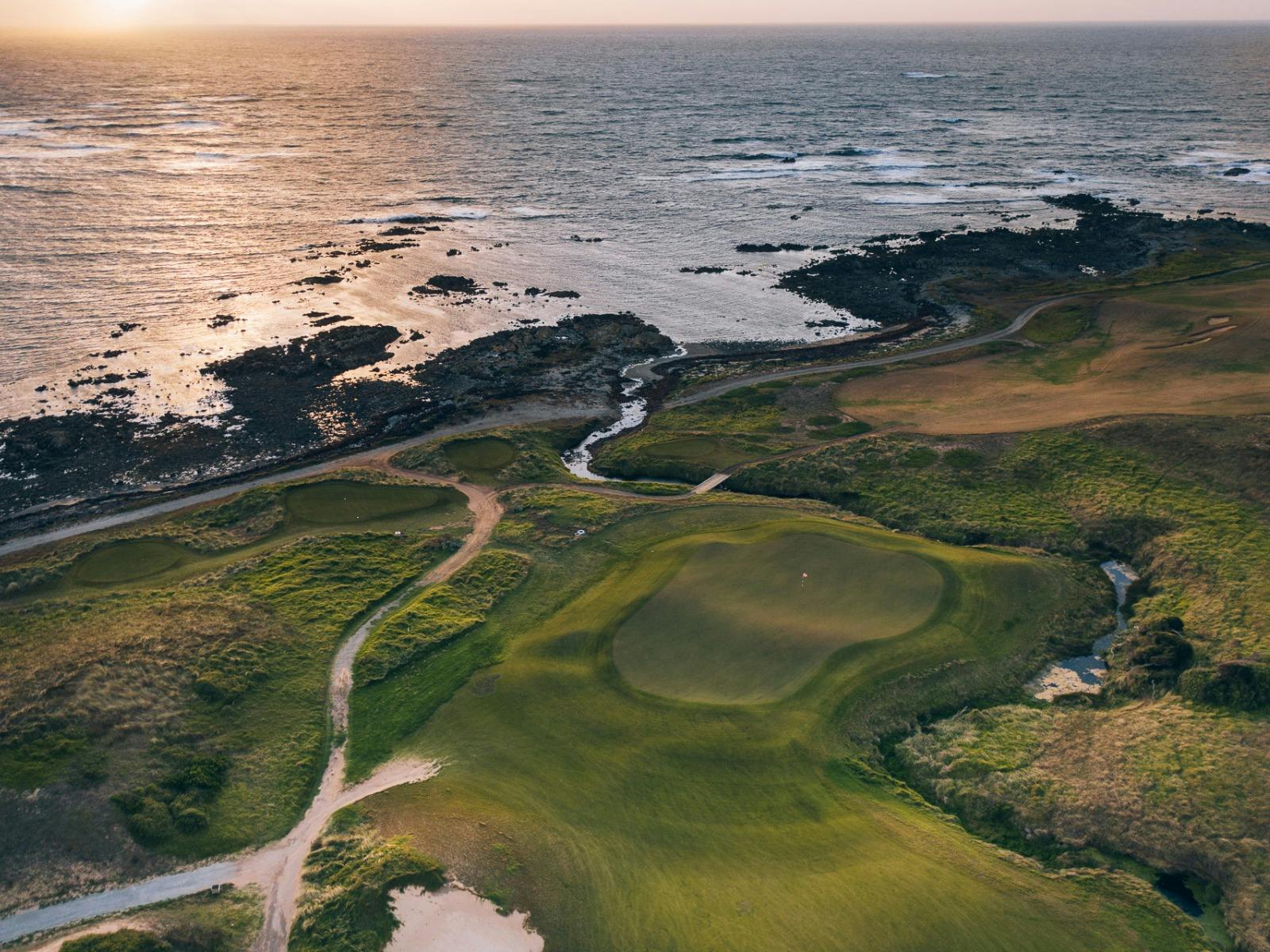 Coastal green at sunset with surrounding ocean and links terrain at Ocean Dunes