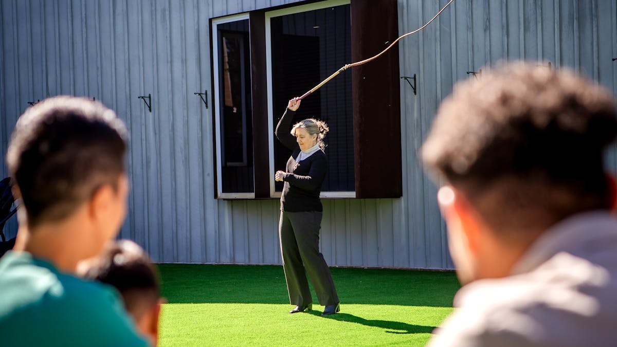 Museum visitors watch a whip-cracking demonstration. Museum visitors watch a whip-cracking demonstration.