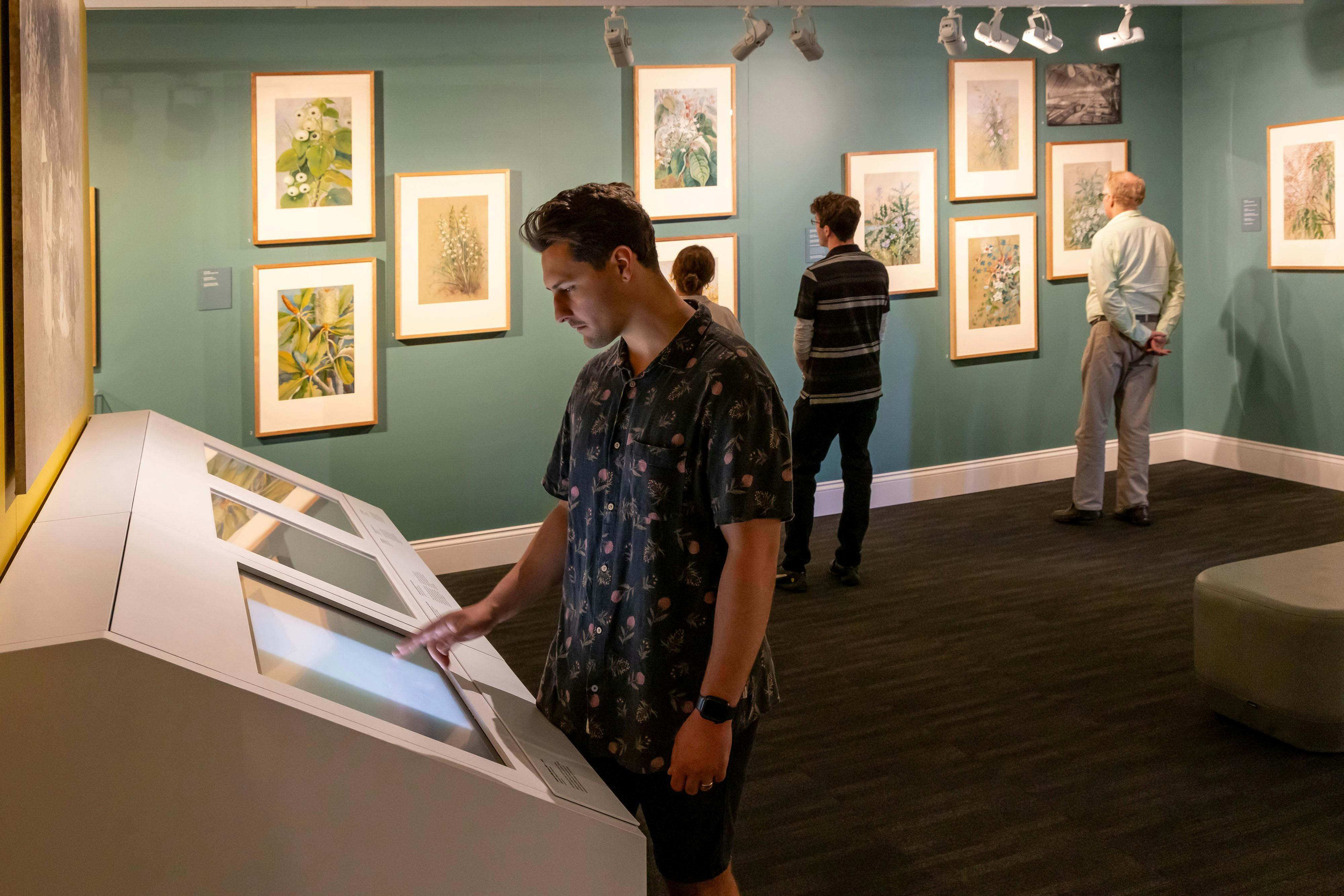 Male visitor using touch screen in exhibiton