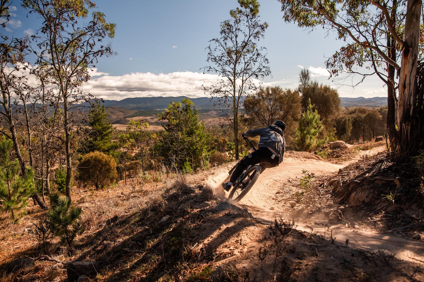 Racer in front of view from Stromlo into the Brindabellas