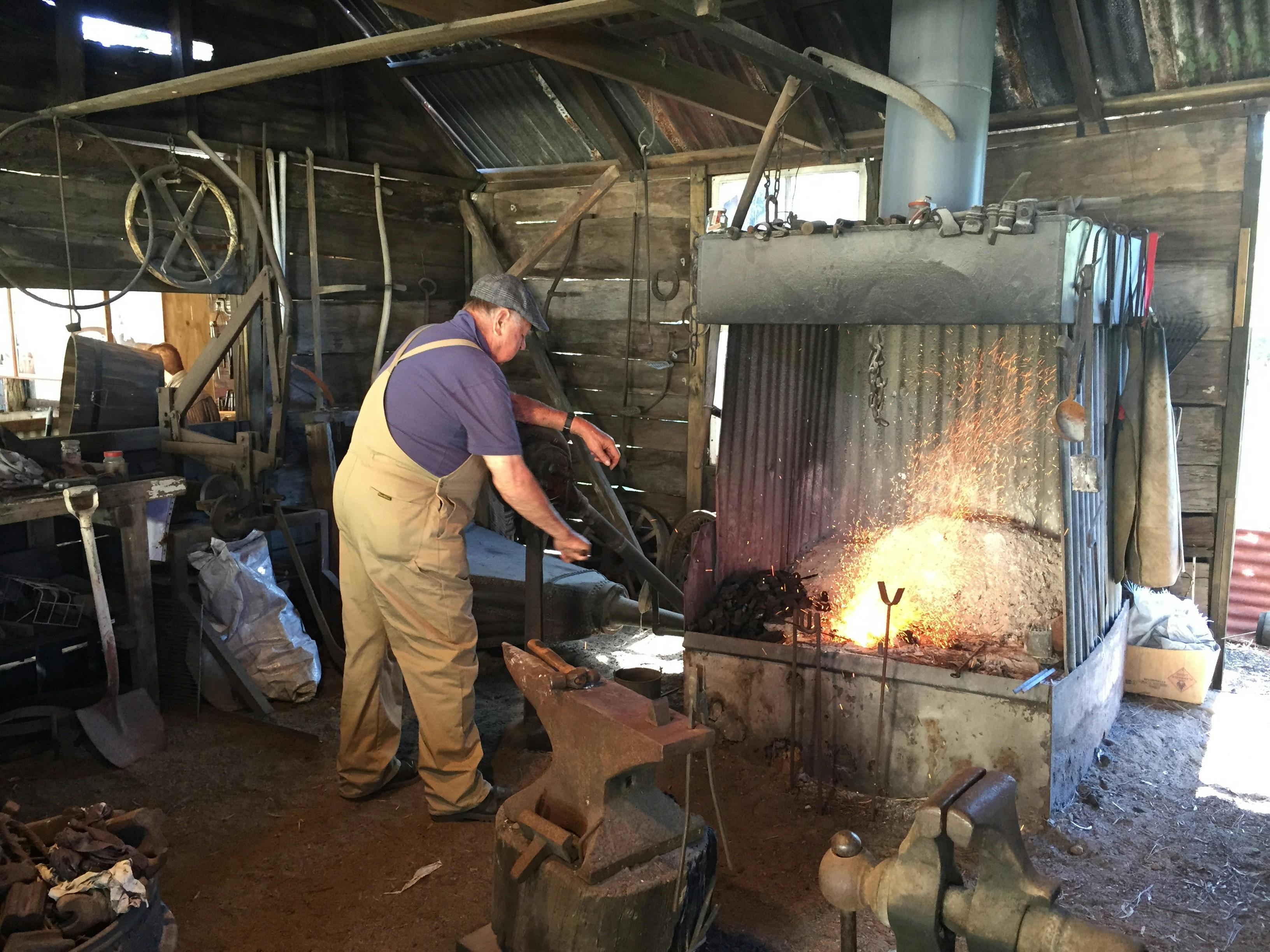 photo showing a blacksmith working metal at Hervey Bay Historical Museum