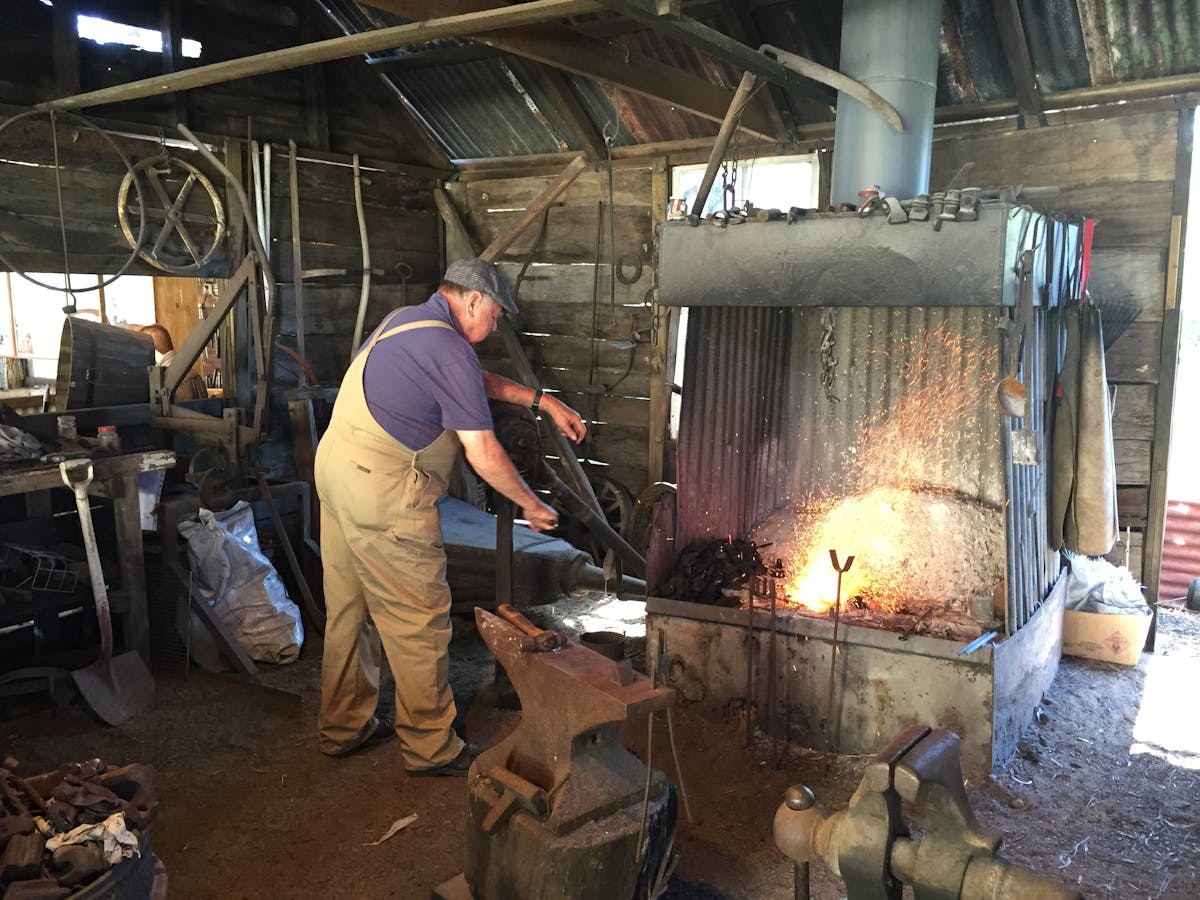 photo showing a blacksmith working metal at Hervey Bay Historical Museum