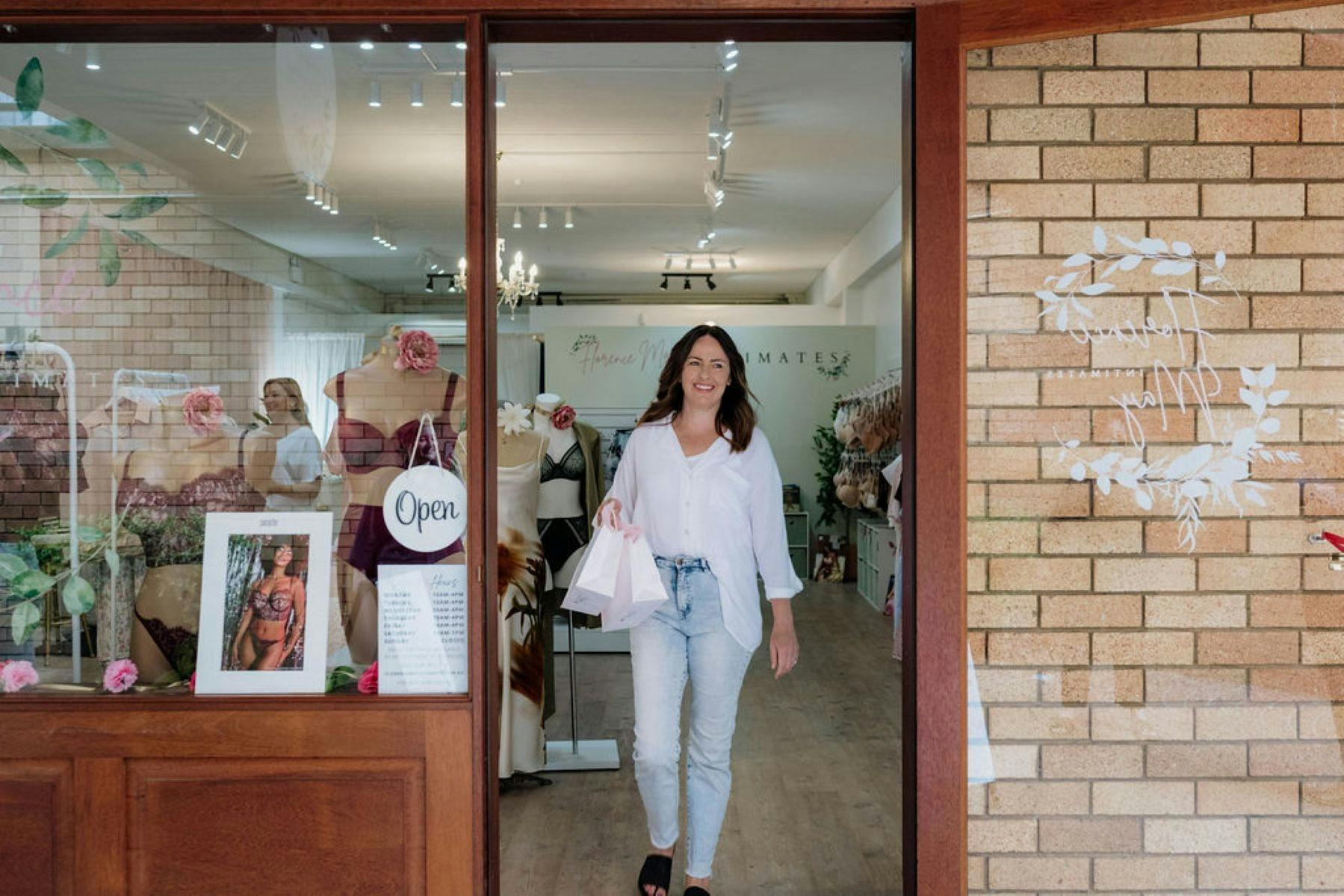 Photo showing entry of Florence May Intimates with woman in doorway