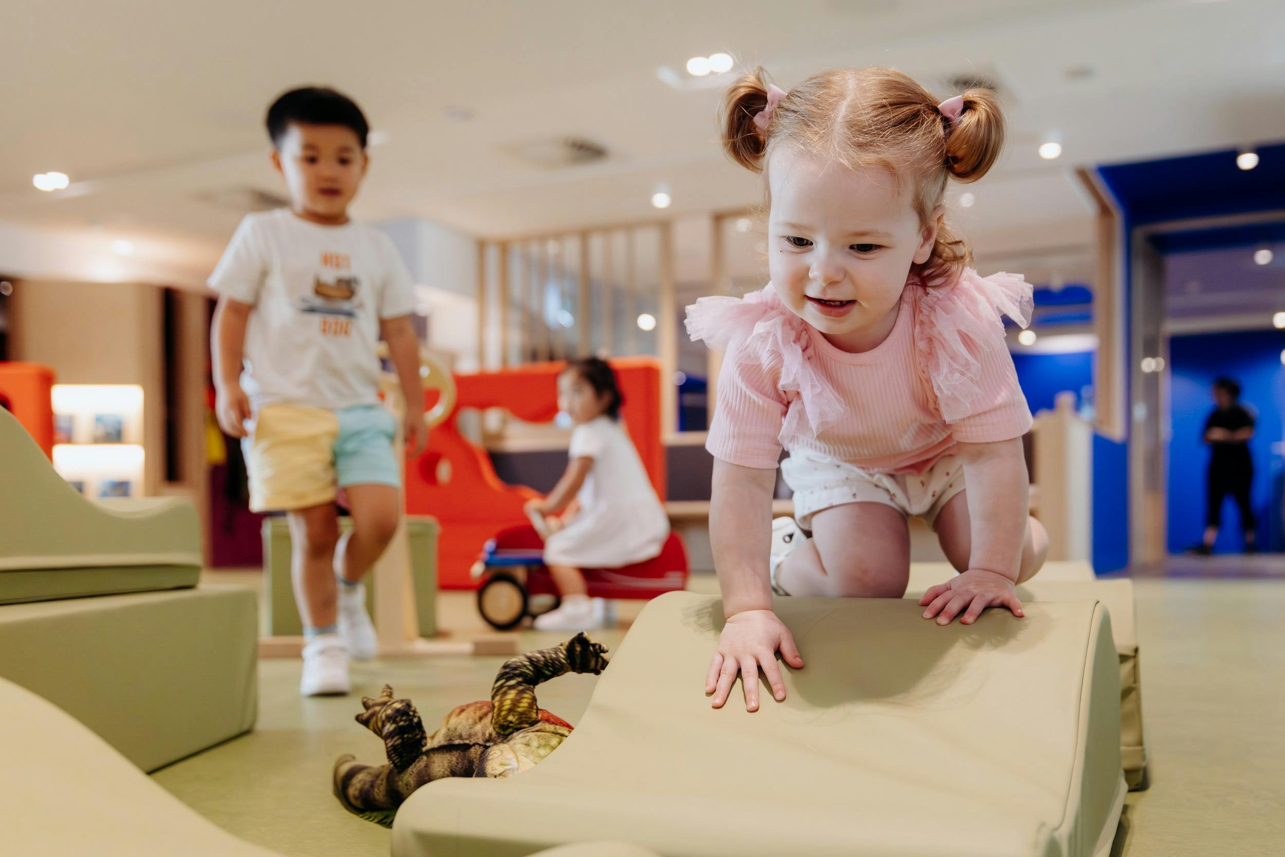 Children climb on soft play blocks at The Corner