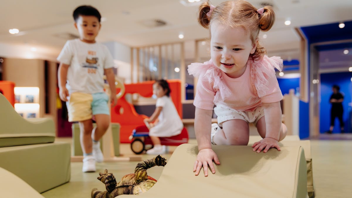 Children climb on soft play blocks at The Corner