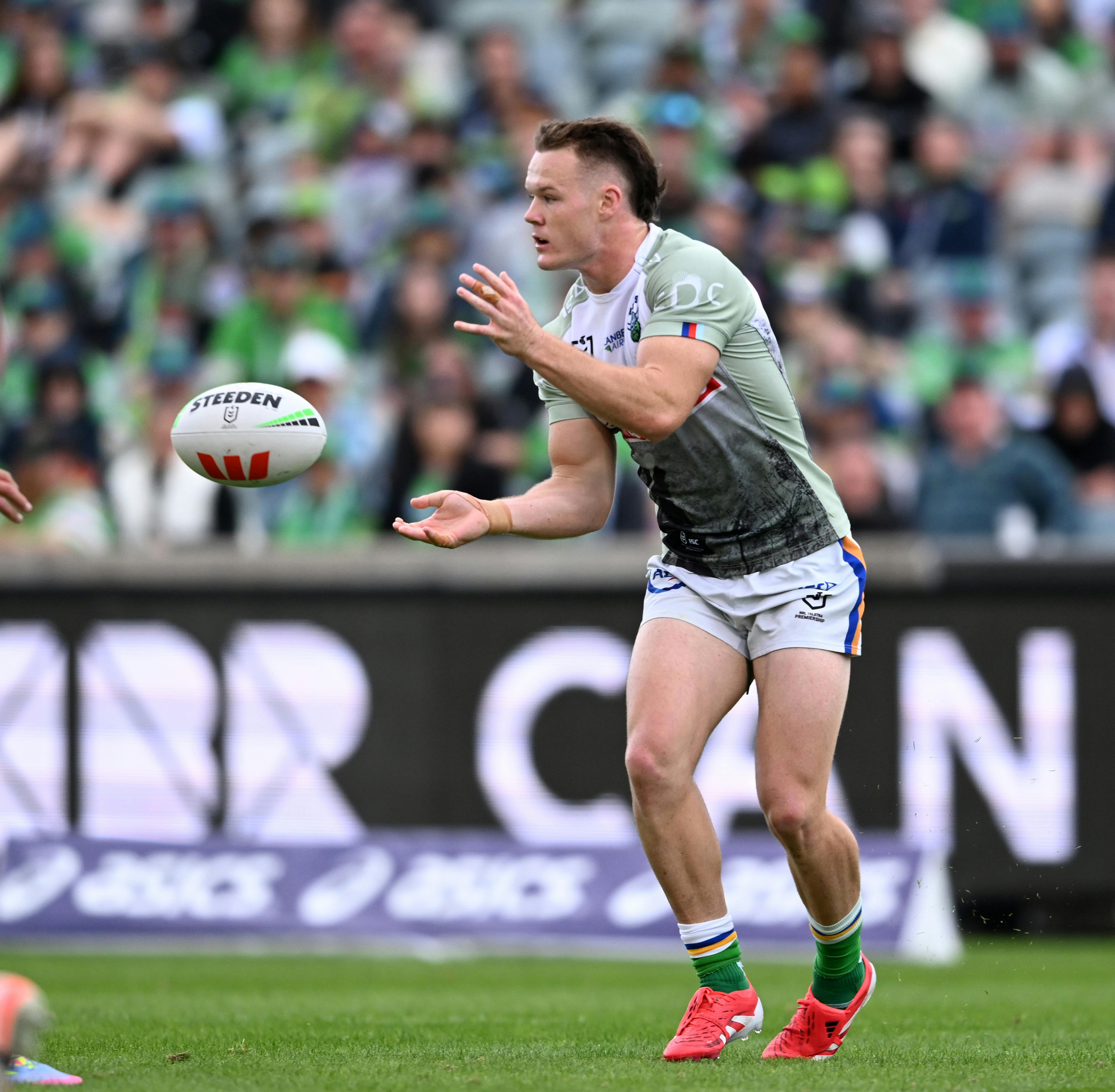 Canberra Raiders player Ethan Strange passing the ball.