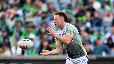 Canberra Raiders player Ethan Strange passing the ball.