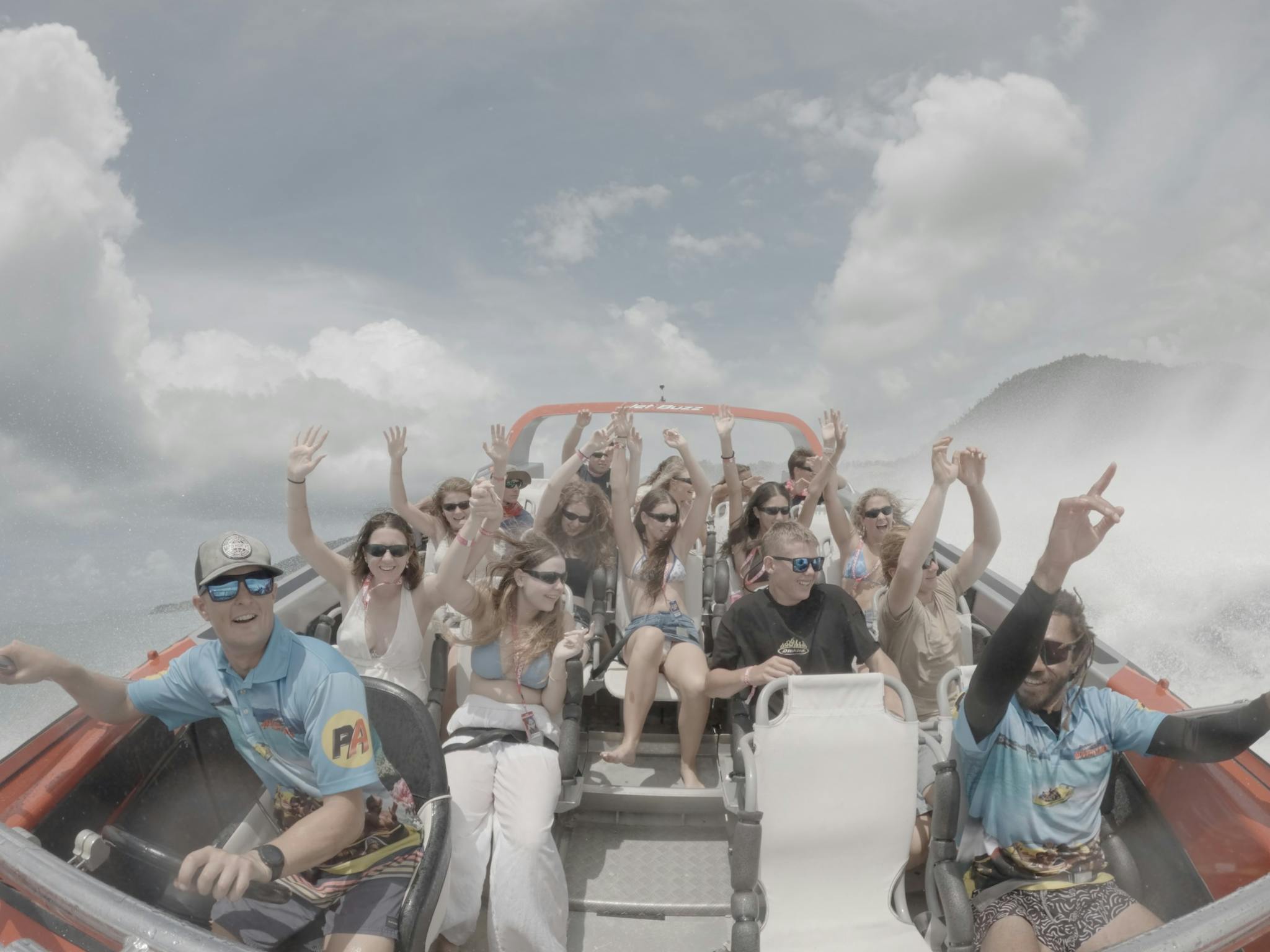 Jetboat midspin with wake in background. Guests and crew hands in the air with excitement. Jetboat midspin with wake in background. Guests and crew hands in the air with excitement.