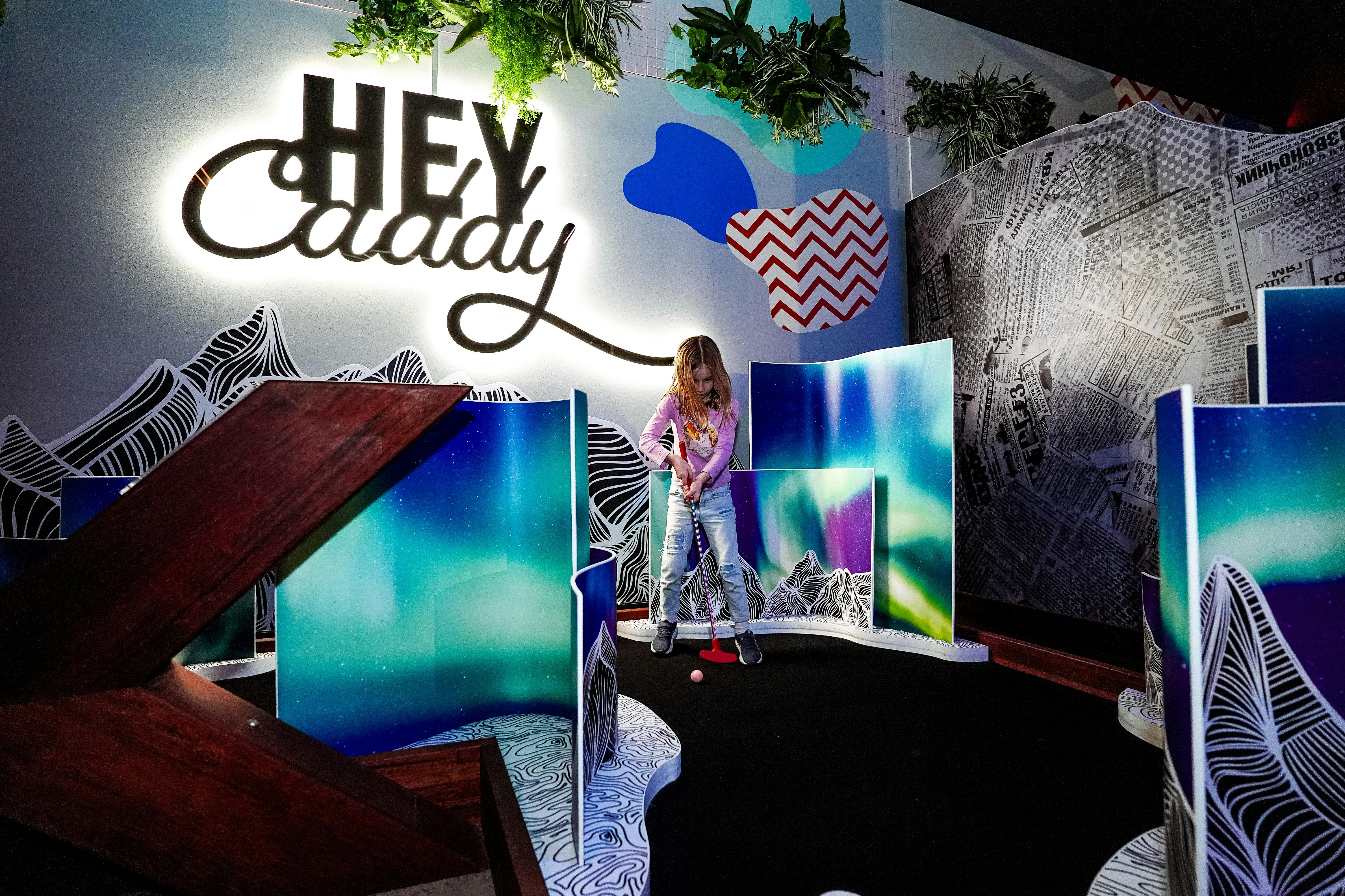 Child Playing Inside Hey Caddy Indoor Mini Golf Venue