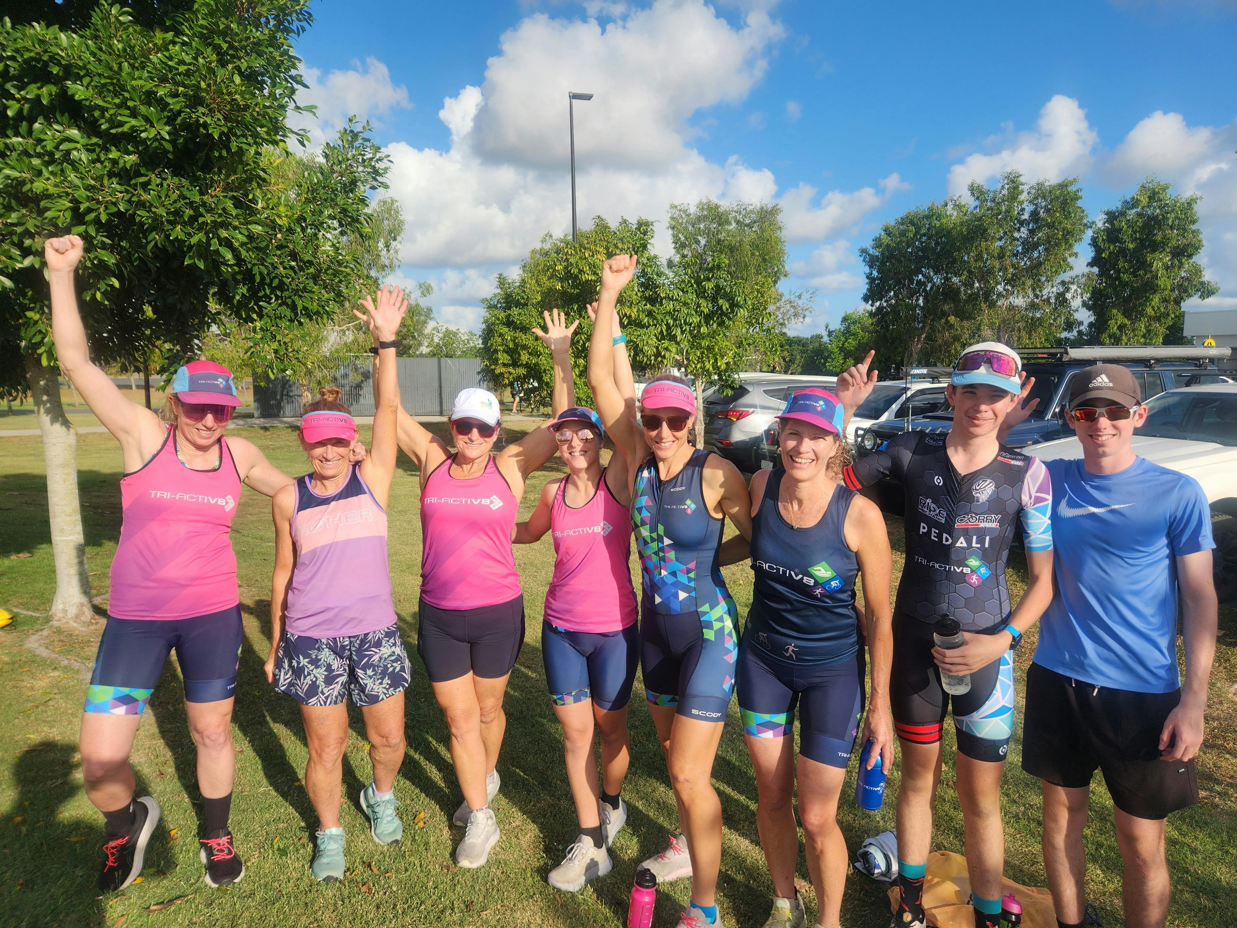 Group of runners in a park looking excited about their run