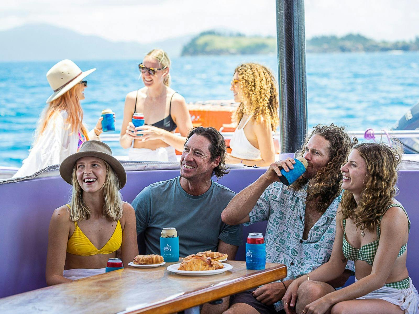 A group of people enjoying lunch on board Camira