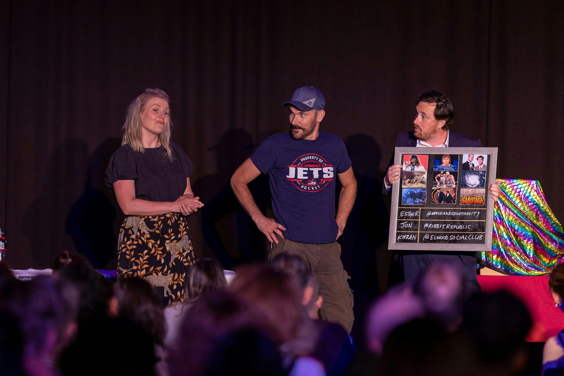 The host and two contestants on the stage