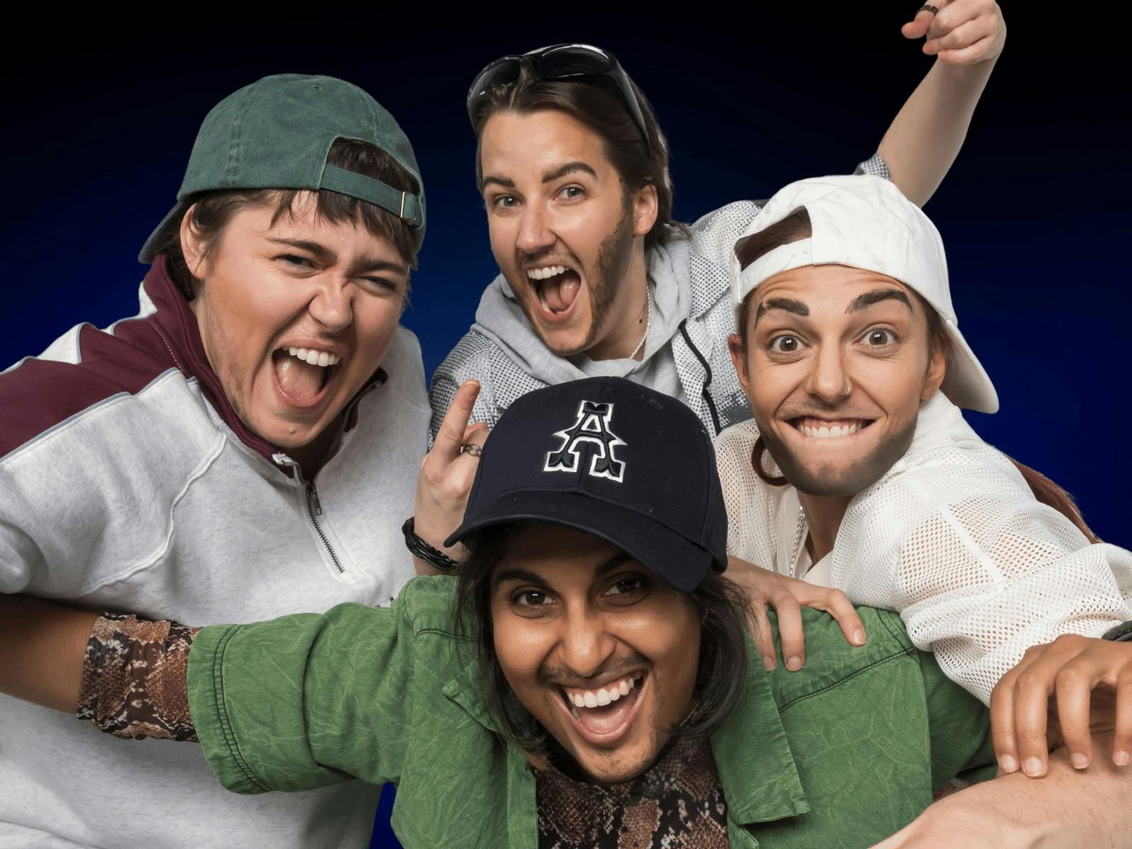 Four Drag Kings dressed as boy band members