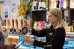 Manager pouring a beer