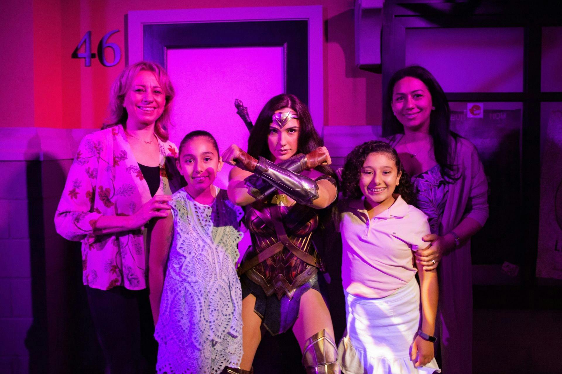 Family posing with Wonder Woman at Madame Tussauds Sydney