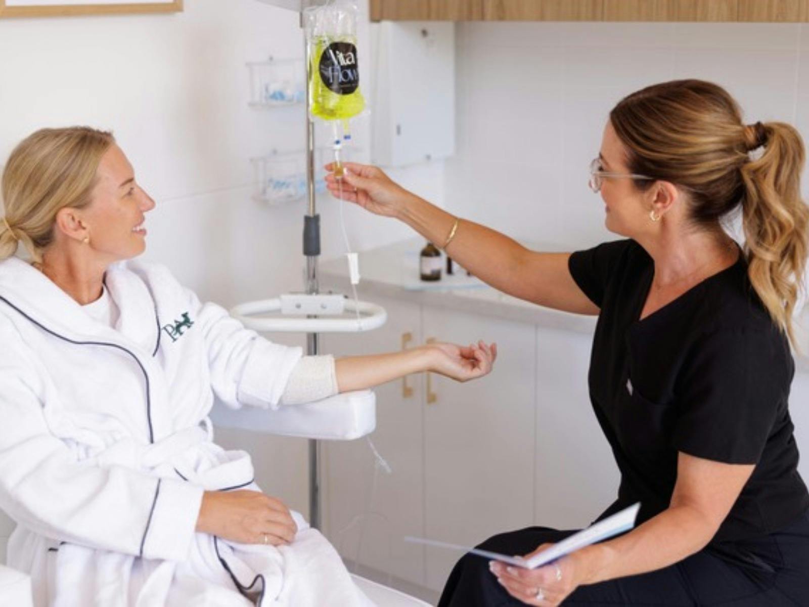 Woman and clinician giving IV Vitamin therapy