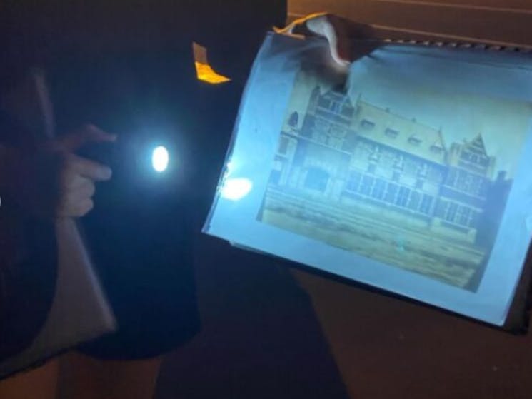 A person holding a light up picture