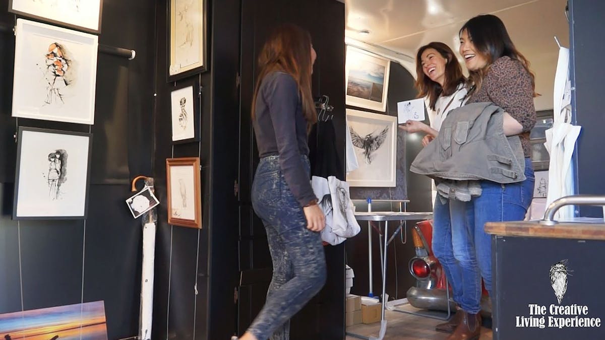 3 people enjoying a visit to the Running Duck Studio caravan Gallery