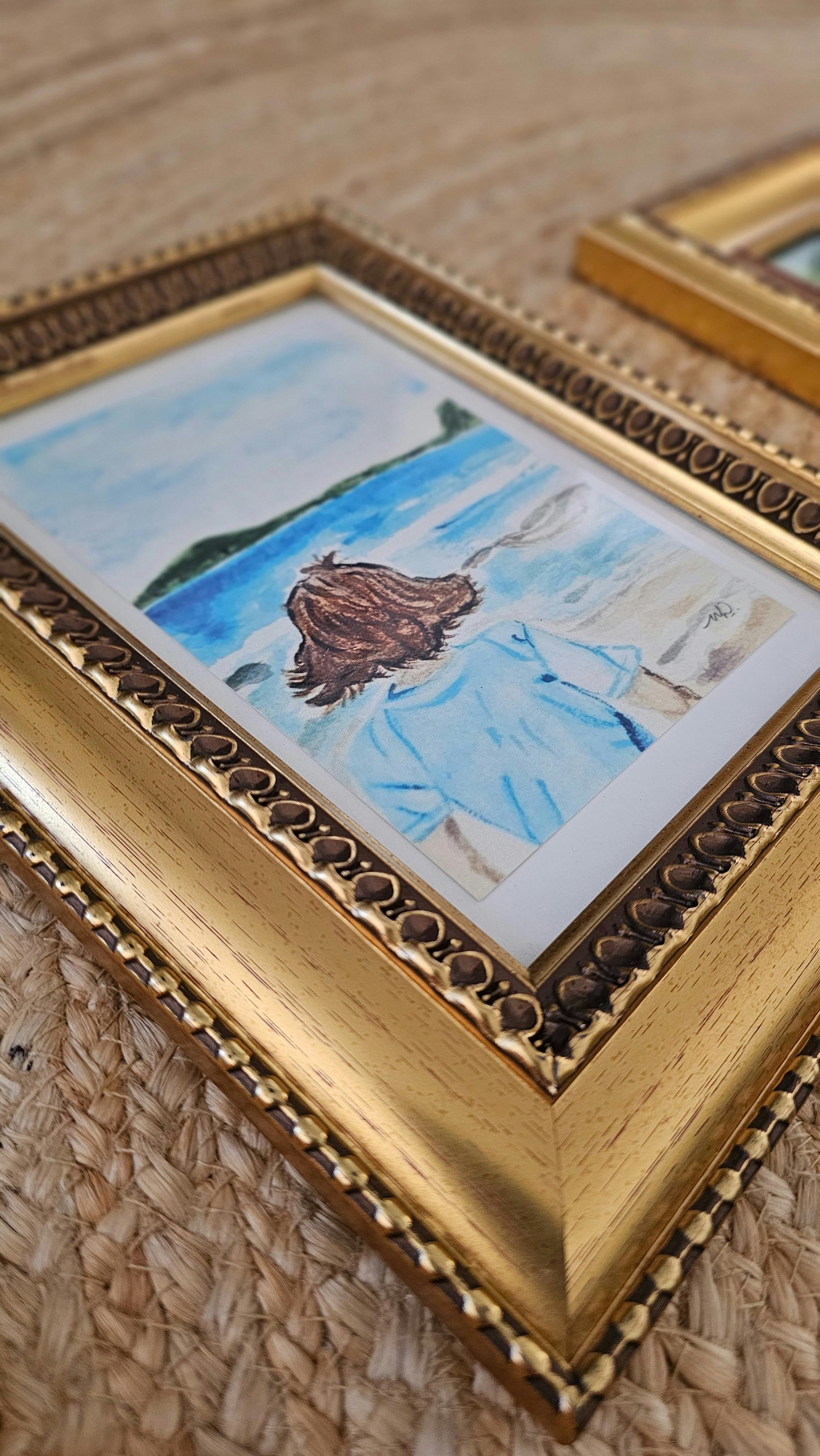 Gold frame with watercolour art of child at the beach