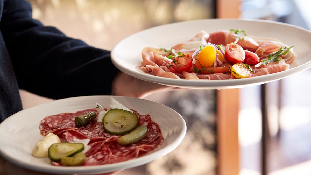 2 plates from the Maleny Food Co small plate menu - cured meats and condiments.