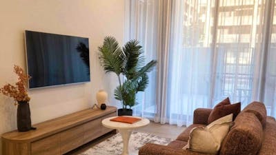 Cozy living space featuring ample natural light from windows and an entertainment center with a tele