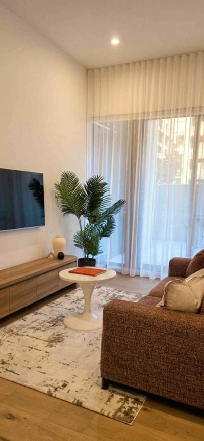 Cozy living space featuring ample natural light from windows and an entertainment center with a tele