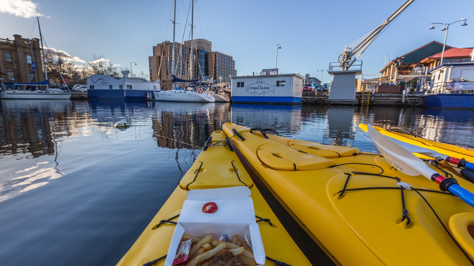 Kayaks in Hobart Docks with fish and chips