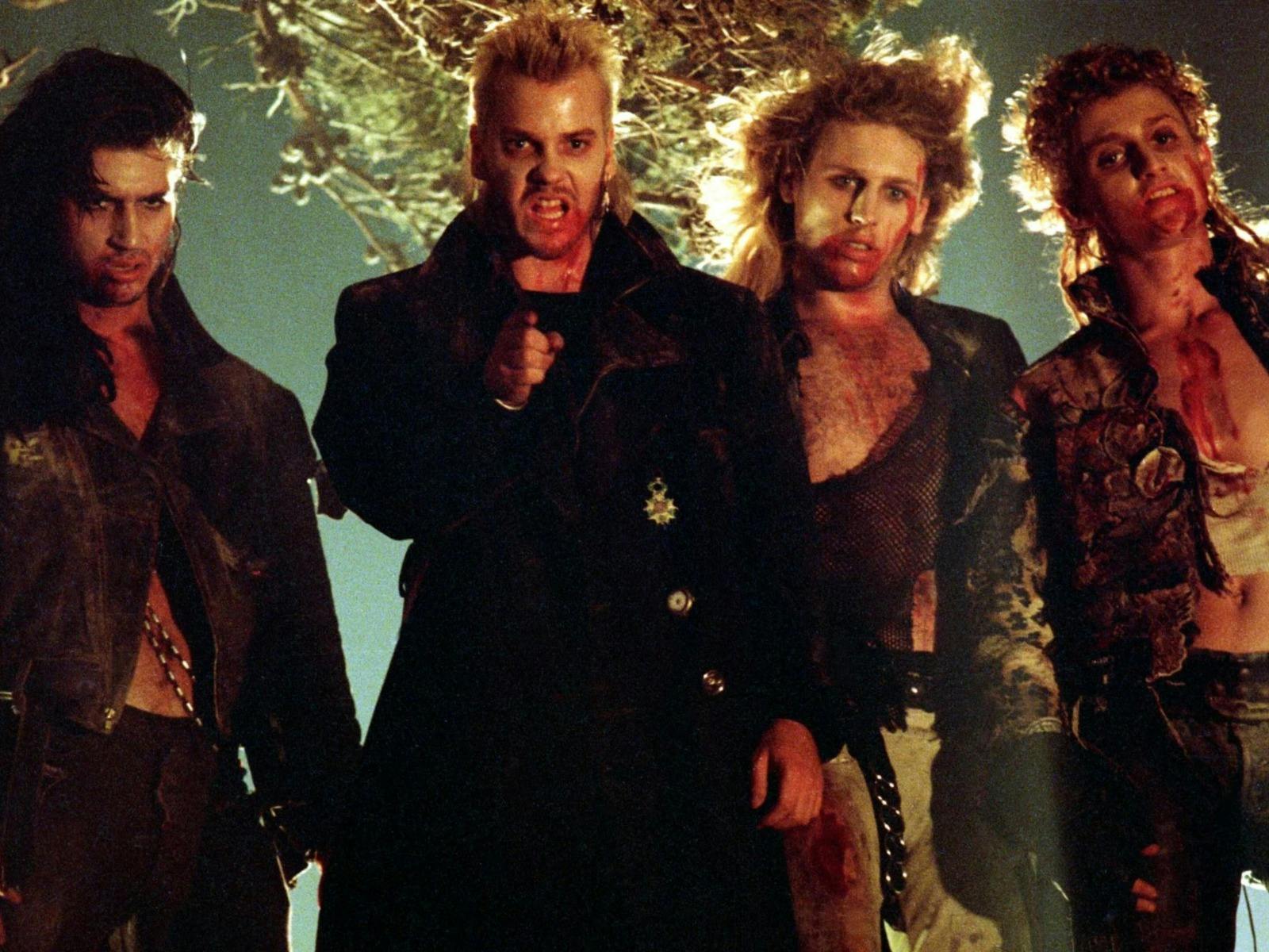 Four men standing covered in blood and gore