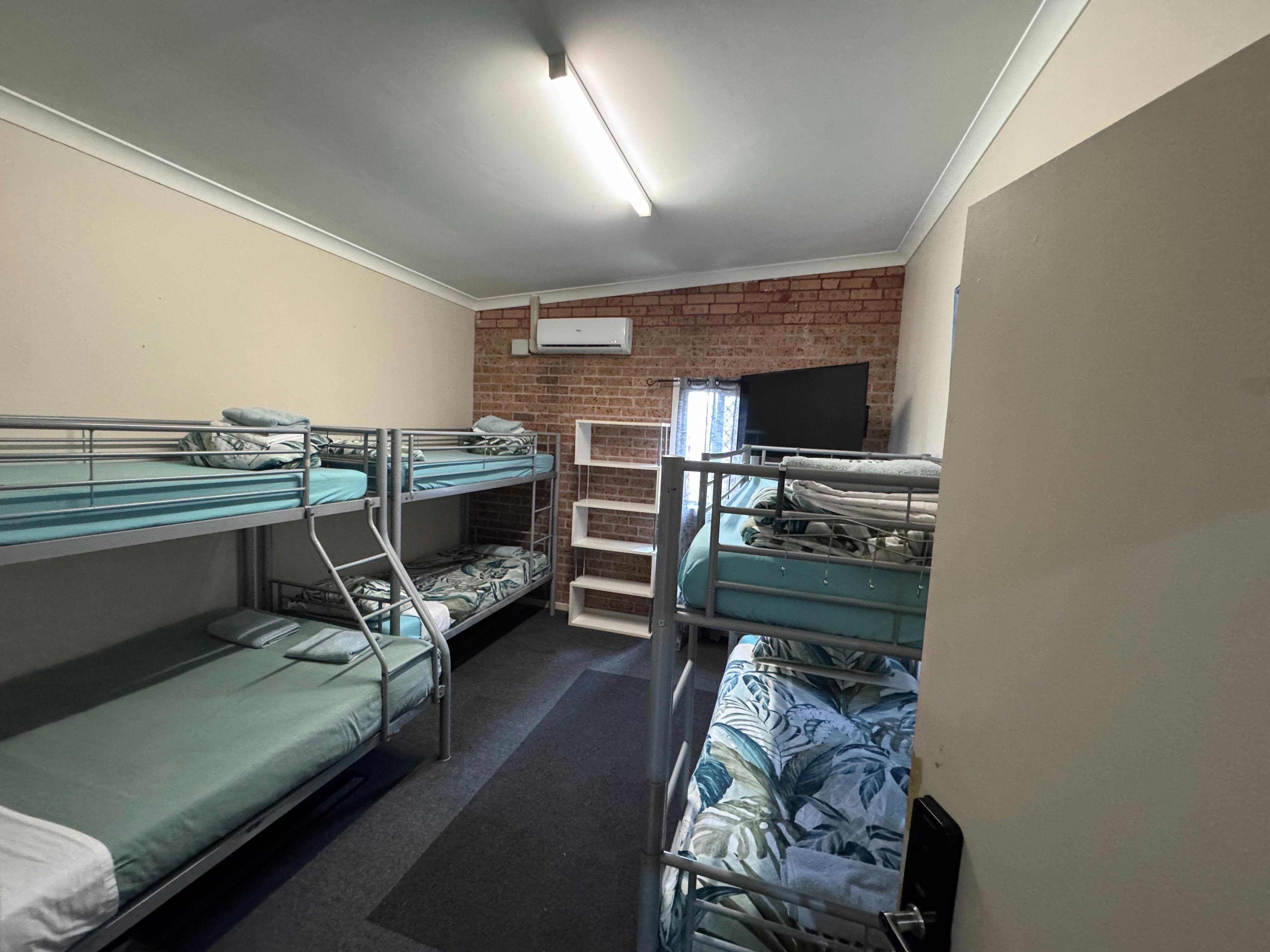 Our Private/Family room, comes with 6 beds in total (one double), air conditioning, mini fridge + TV