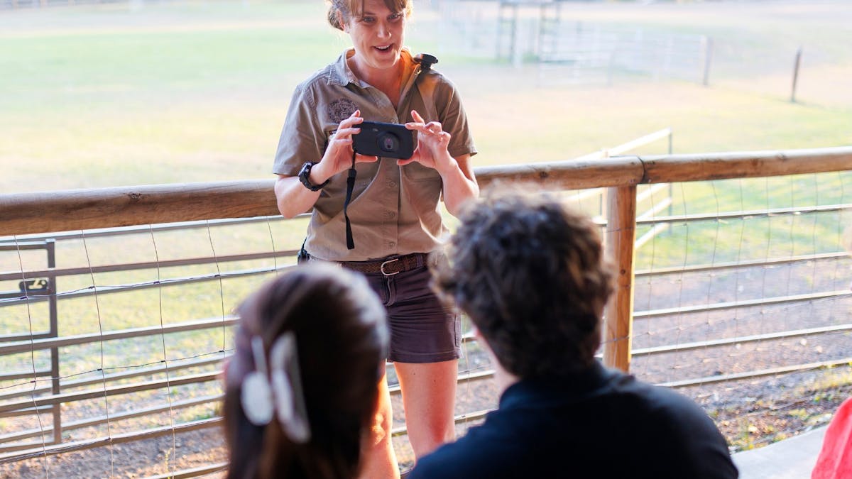 Sanctuary guide showing a night vision device to visitors at Lone Pine before a nocturnal wildlife
