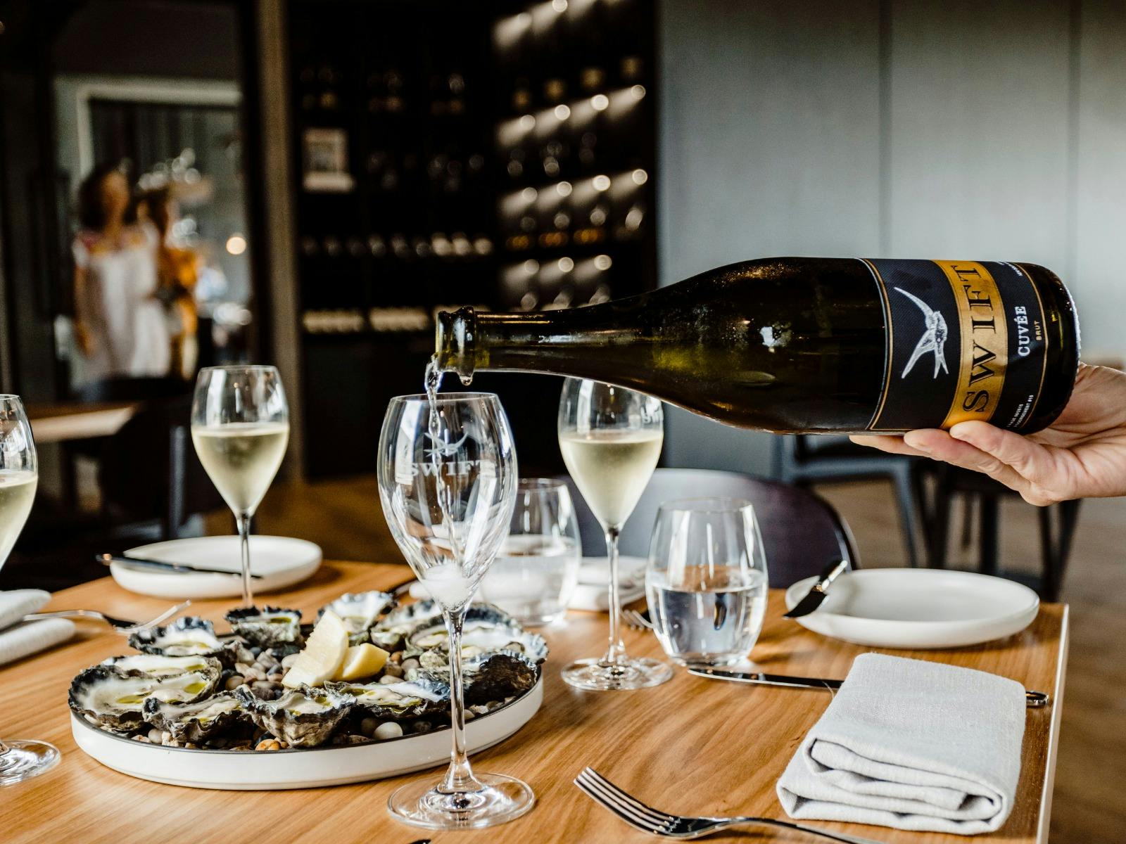 Bottle of Swift Sparkling being poured at a restaurant table at Printhie Dining