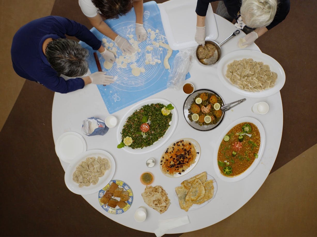 Arial view of people around a round table full of platters of food