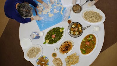Arial view of people around a round table full of platters of food