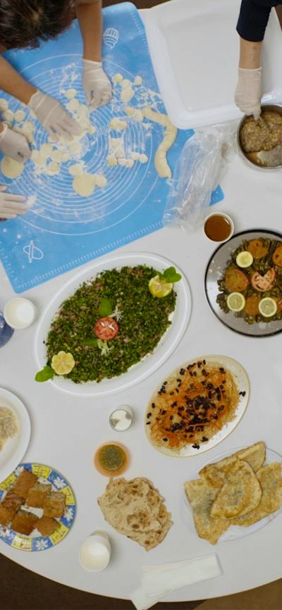 Arial view of people around a round table full of platters of food