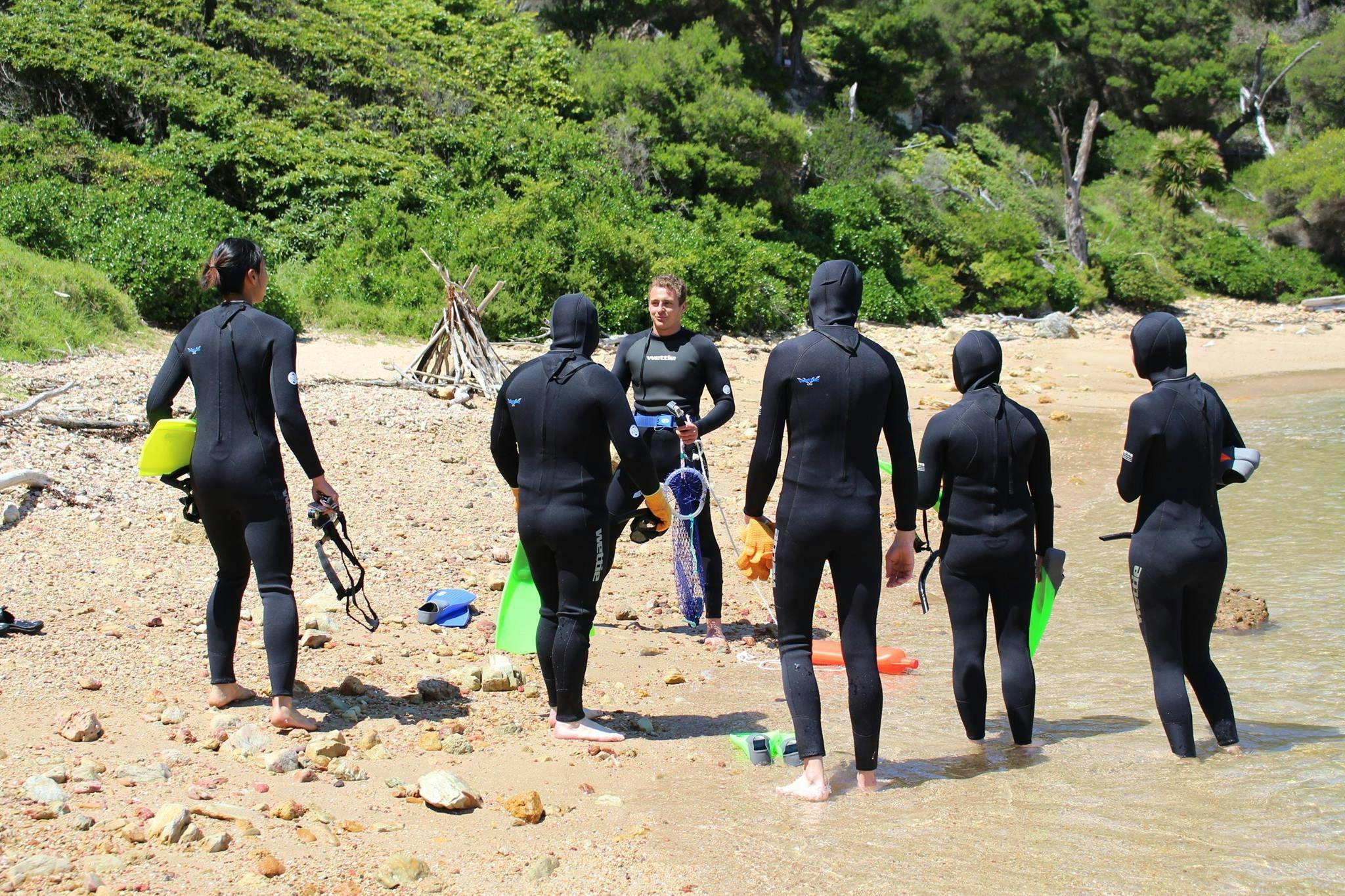 Guide delivering information to customers that are geared up ready to go snorkelling.