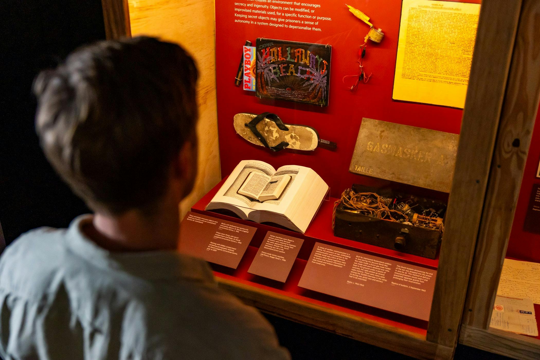 Man engaging with exhibition panels and objects